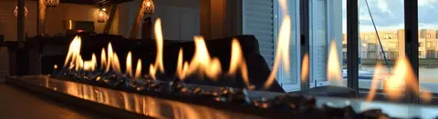 Linear fireplace glowing in the lounge