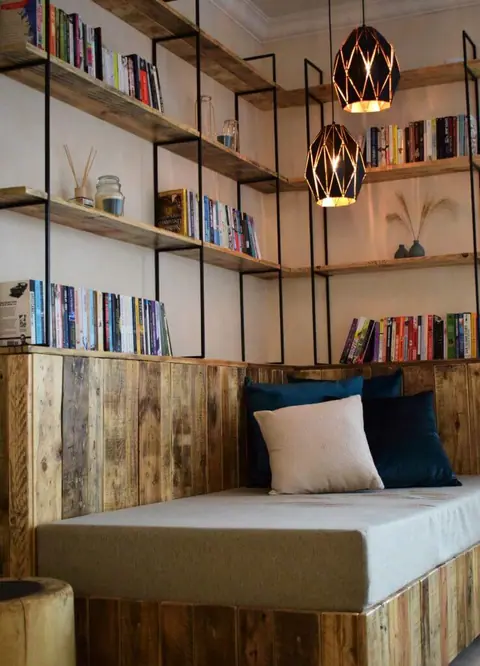 Reading nook with a daybed and wooden bookshelves