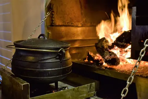 Potjie pot beside the fire in the indoor braai