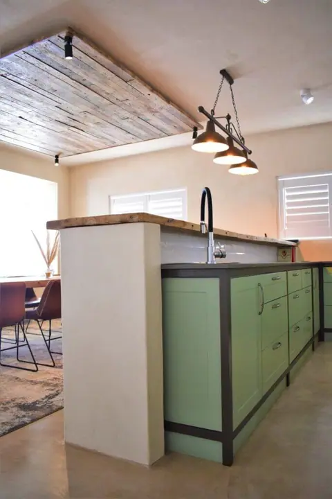 Kitchen island with sage-green cabinets