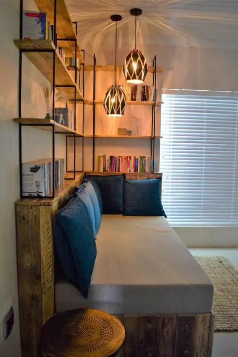 Daybed reading nook with bookshelves and pendant lights