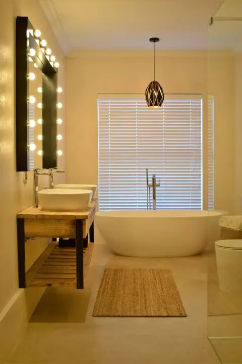 En-suite with a free-standing bath and lit mirror