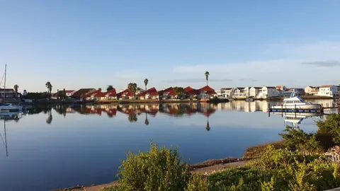 Calm marina water reflecting the waterfront homes