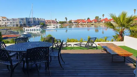 Patio with outdoor dining furniture overlooking the marina